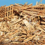 A large pile of wooden debris mostly from planks and pallets.